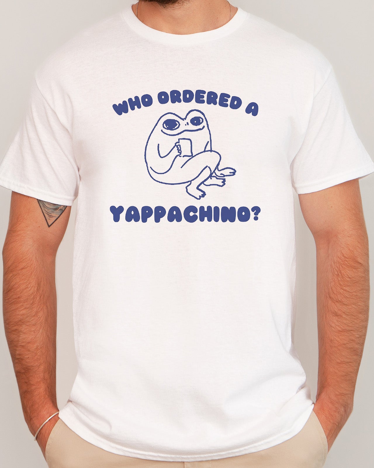 a man wearing a who ordered a yappachino shirt in white color