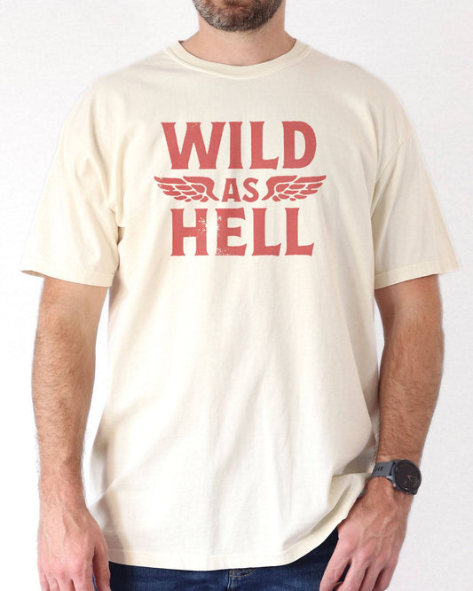 Man wearing ivory "Wild As Hell" retro western graphic shirt.