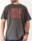 Man wearing pepper "Wild As Hell" retro western graphic shirt.