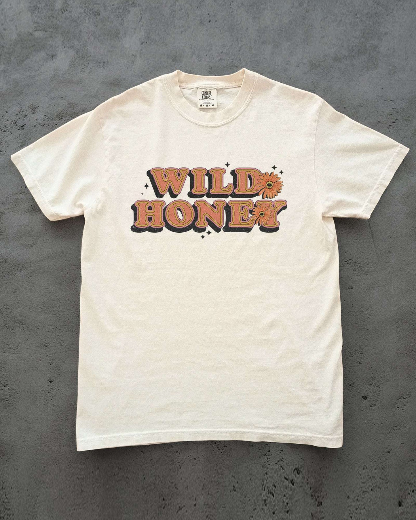 Flat Lay Wild Honey shirt laying on concrete in ivory color