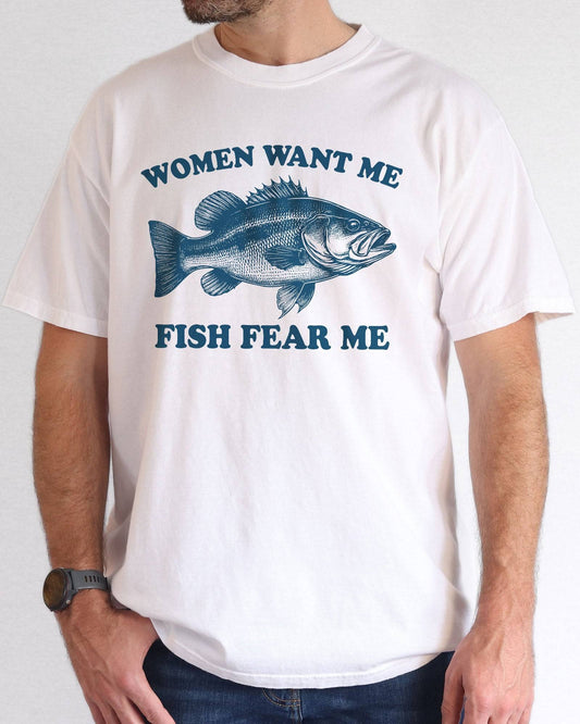 Model wearing white color shirt with 'Women Want Me Fish Fear Me' graphic design