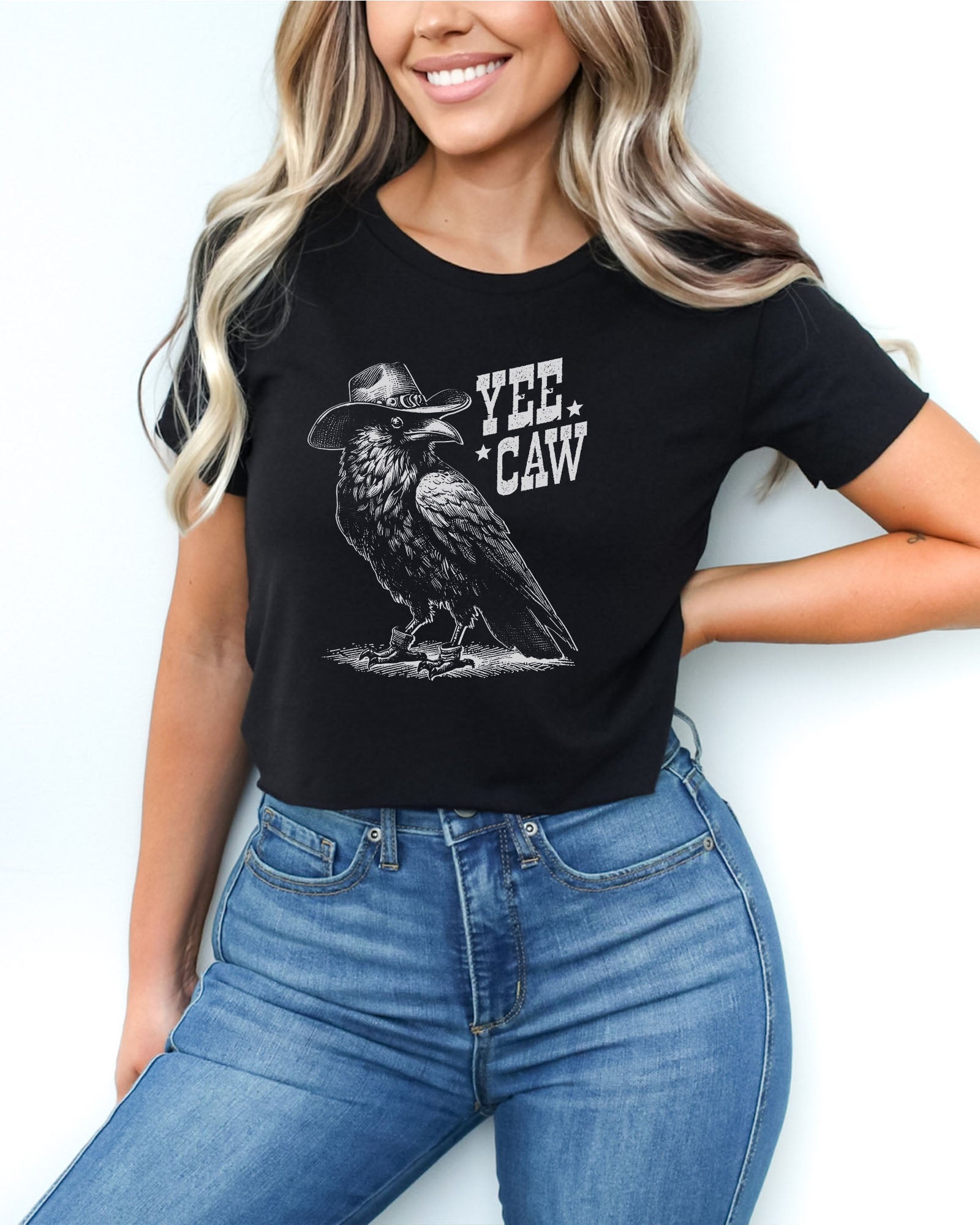 Woman wearing black-colored 'Yee Caw' crop top featuring a funny retro cowboy crow graphic.