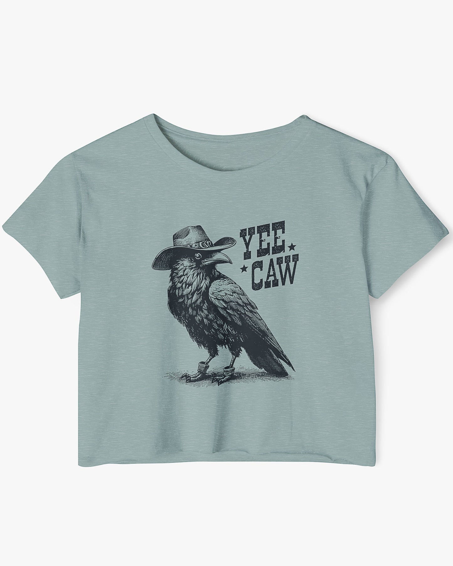 Woman wearing stonewash-green-colored 'Yee Caw' crop top featuring a funny retro cowboy crow graphic.