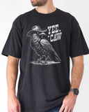 Man wearing black-colored 'Yee Caw' shirt featuring a funny retro cowboy crow graphic.