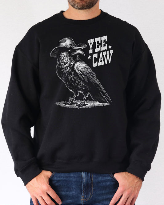 Man wearing a black sweatshirt featuring a funny retro-style cowboy crow graphic and the quote 'Yee Caw'.