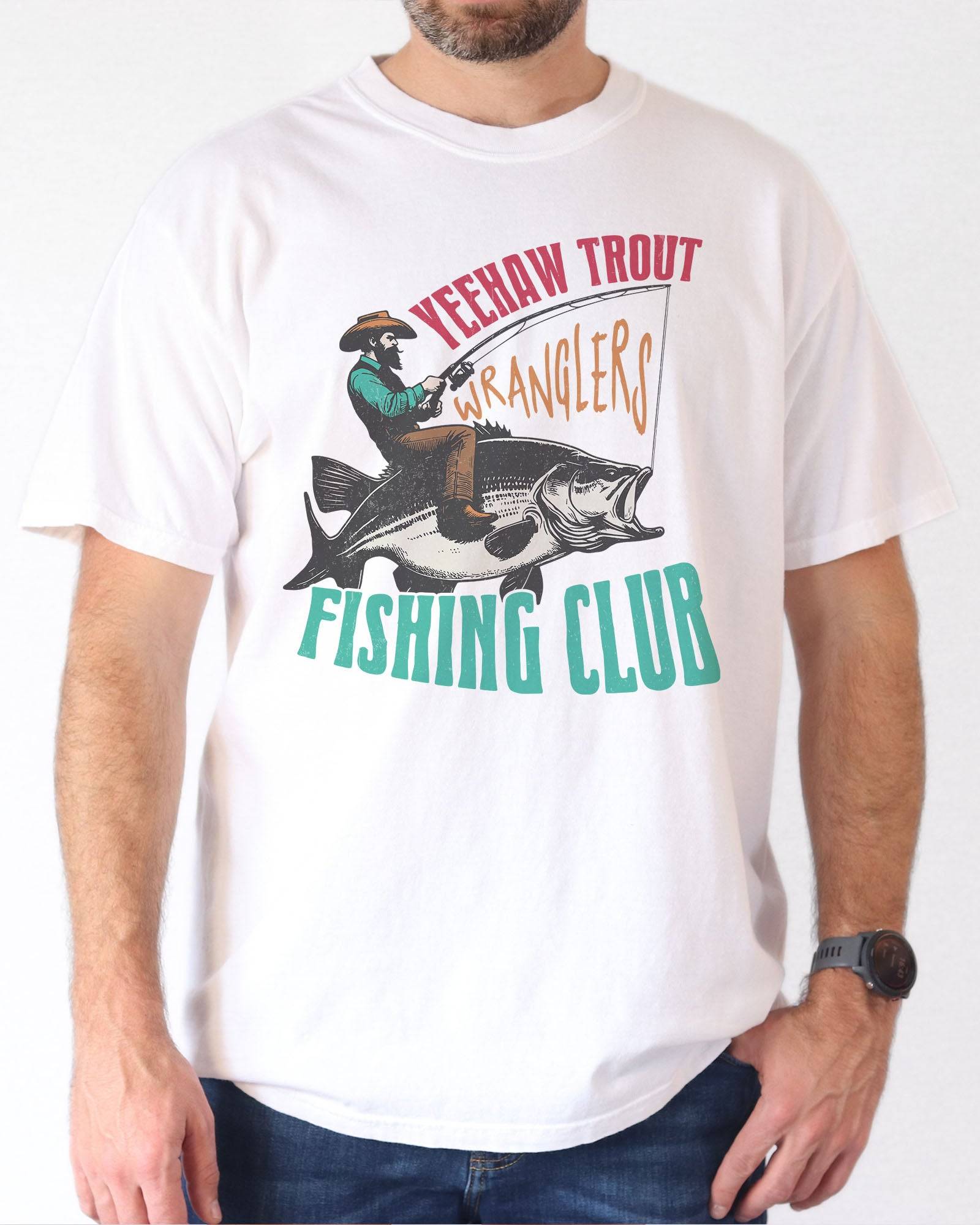 Model wearing white color shirt with 'Yeehaw Trout Wranglers Fishing Club' graphic design