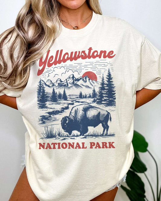 Woman wearing "Yellowstone National Park" shirt in ivory with retro graphic of buffalo and nature scenery