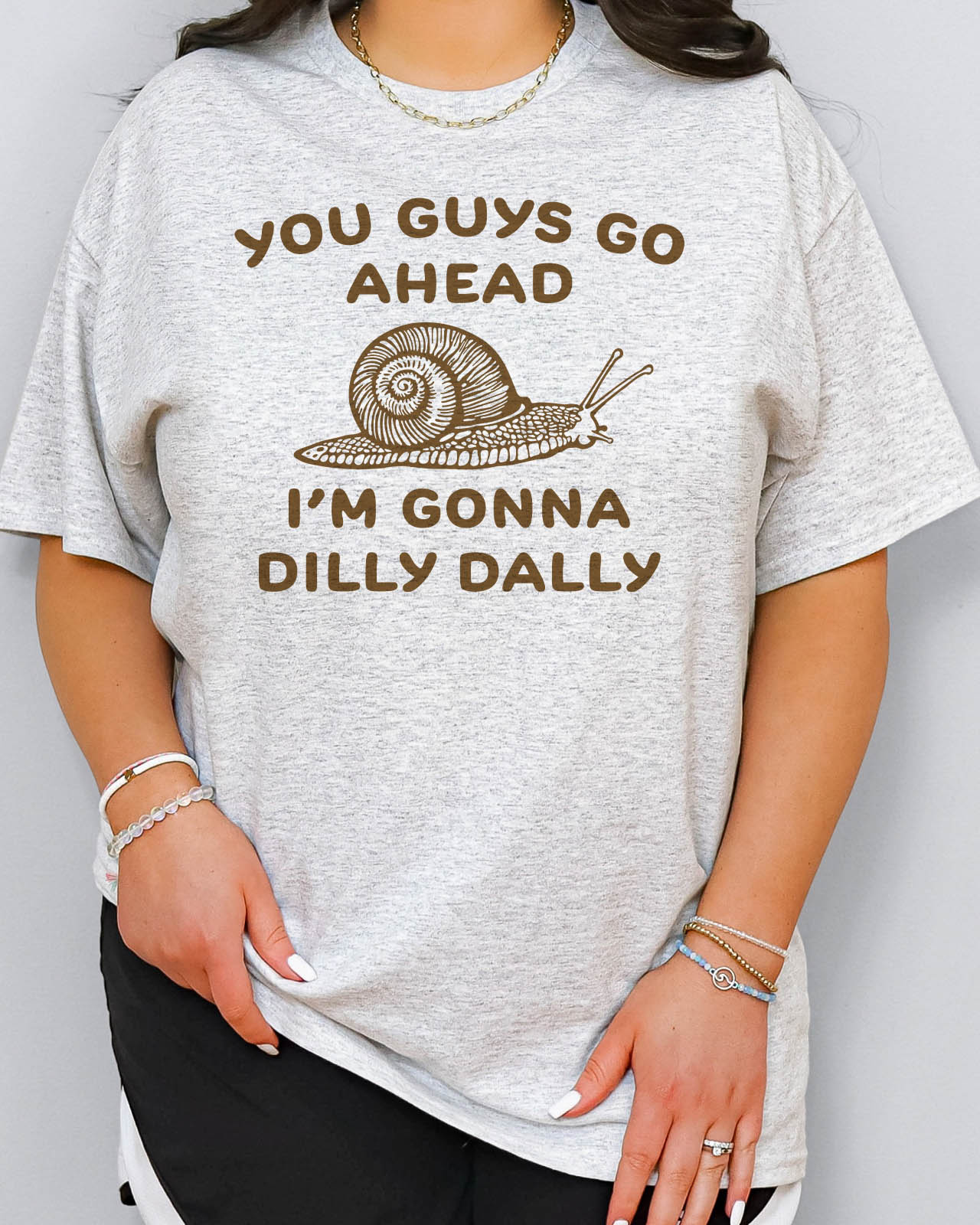 You Guys Go Ahead I'm Gonna Dilly Dally shirt in ash grey color with a retro snale graphic