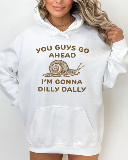 Woman wearing a white hoodie with a funny retro-style snail graphic and the quote 'You Guys Go Ahead, I'm Gonna Dilly Dally'.