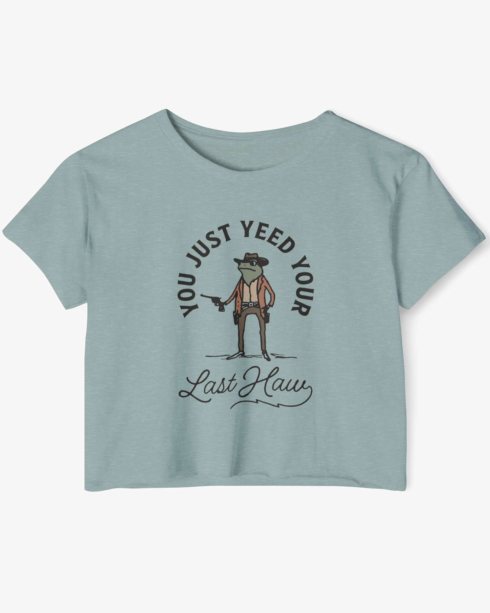 Flat lay of a stonewash green crop top with a funny retro cowboy sheriff frog graphic and the text 'You Just Yeed Your Last Haw'.