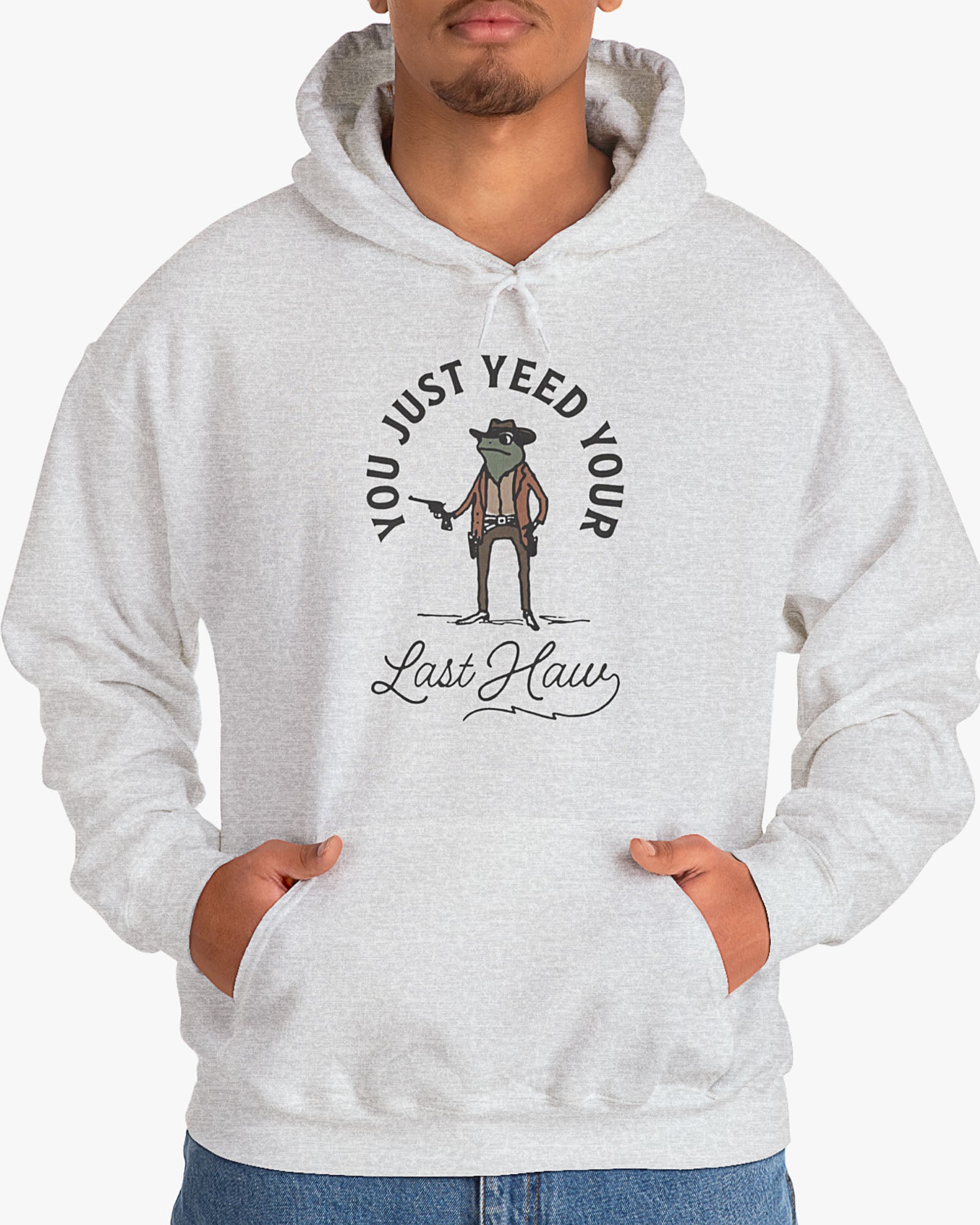 Man wearing ash gray 'You Just Yeed Your Last Haw' hoodie with funny retro cowboy frog graphic