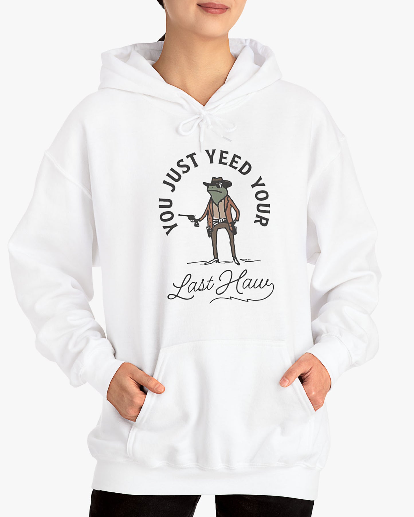 Woman wearing white 'You Just Yeed Your Last Haw' hoodie with funny retro cowboy frog graphic