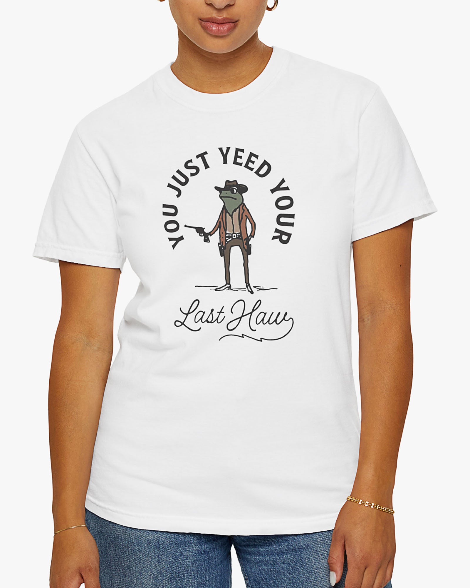 Woman wearing white 'You Just Yeed Your Last Haw' shirt with funny retro cowboy frog graphic
