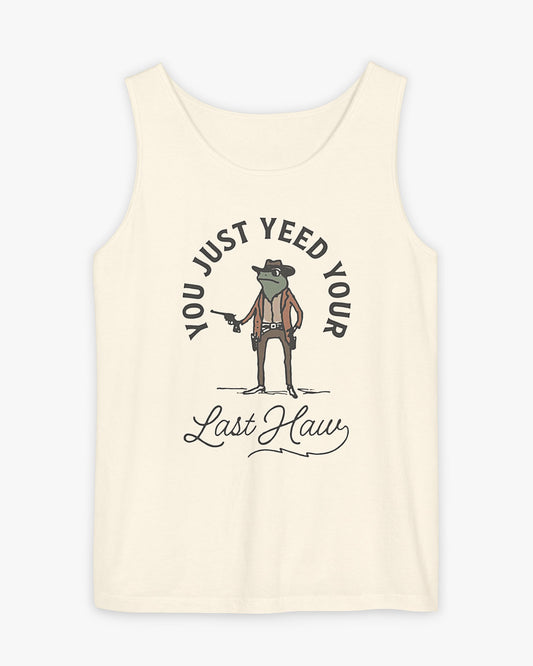 Flat laying natural 'You Just Yeed Your Last Haw' tank top with funny retro cowboy frog graphic