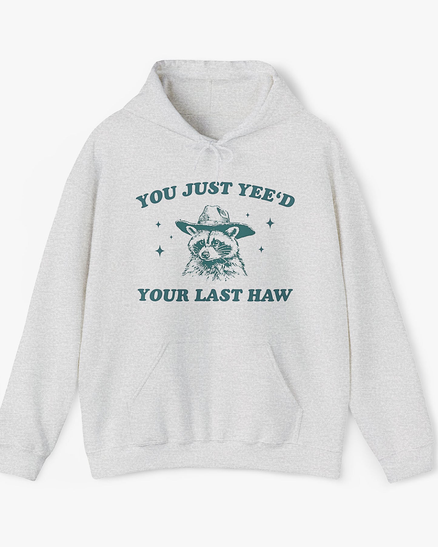 Flat laying ash gray 'You Just Yeed Your Last Haw' hoodie with funny cowboy raccoon graphic