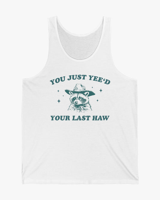 Flat laying white 'You Just Yeed Your Last Haw' tank top with funny retro cowboy raccoon graphic