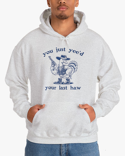 Man wearing ash gray 'You Just Yeed Your Last Haw' hoodie with funny retro cowboy goose graphic