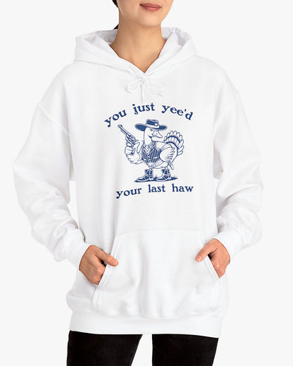 Woman wearing white 'You Just Yeed Your Last Haw' hoodie with funny retro cowboy goose graphic