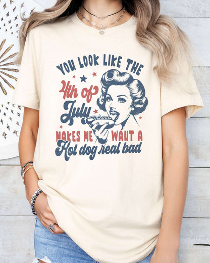 Model wearing natural  color shirt with 'You Look Like The 4th Of July' graphic design