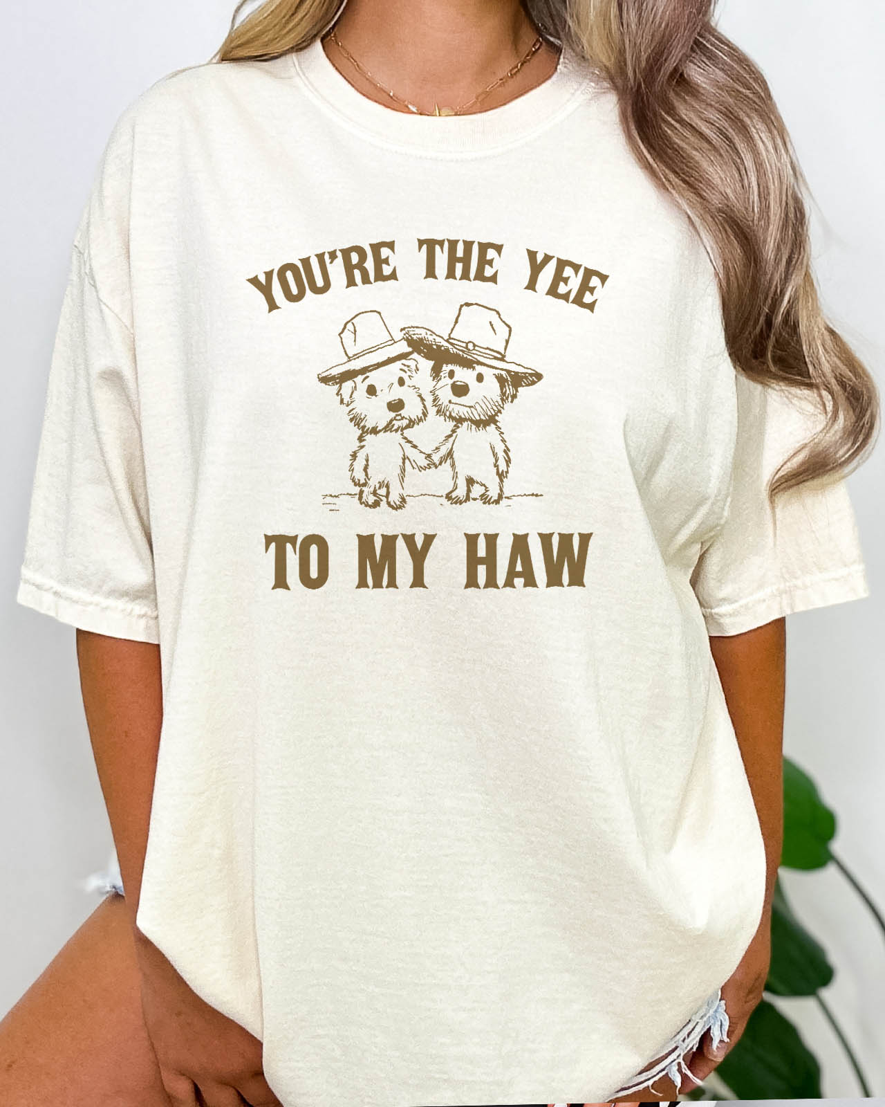 Woman wearing "You're the yee to my haw" shirt in natural beige color