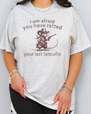 Woman wearing "You Have Ratted Your Last Tatouille" Shirt in ash grey color with a retro cowboy rat graphic
