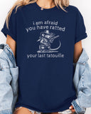 Woman wearing "You Have Ratted Your Last Tatouille" Shirt in navy blue color with a retro cowboy rat graphic